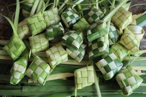 Ketupat or Rice Dumplings. Ketupat is a natural rice sleeve made from young coconut leaves to cook rice which is always available during Islamic holidays photo