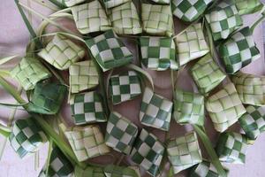 Ketupat or Rice Dumplings. Ketupat is a natural rice sleeve made from young coconut leaves to cook rice which is always available during Islamic holidays photo