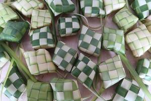 Ketupat or Rice Dumplings. Ketupat is a natural rice sleeve made from young coconut leaves to cook rice which is always available during Islamic holidays photo