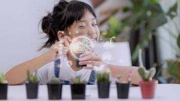 Little girl watching a plant. Environmental technology concept. Sustainable development goals. SDGs. photo