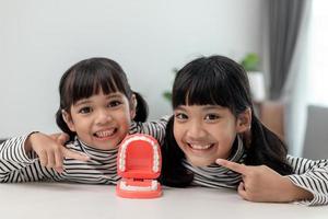 little girl smiling with a happy and cool smile on face. showing teeth. photo