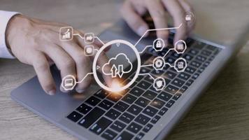 man use Laptop with cloud computing diagram show on hand. Cloud technology. Data storage. Networking and internet service concept. photo