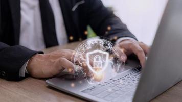Cyber Security Internet And Networking Concept. Businessman Hand Working With laptop computer and virtual Screen Padlock Icon. Digital crime by an anonymous hacker, data protection. photo