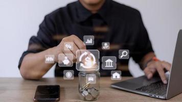 Businessman using a computer to Concept of fund financial investment management portfolio diversification photo