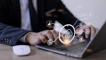 man use Laptop with cloud computing diagram show on hand. Cloud technology. Data storage. Networking and internet service concept. photo