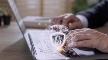 Cyber Security Internet And Networking Concept. Businessman Hand Working With laptop computer and virtual Screen Padlock Icon. Digital crime by an anonymous hacker, data protection. photo