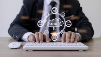 Man doing cloud uploading on laptop computer at office photo