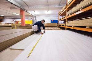 carpenter measuring wooden board photo