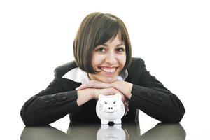 business woman putting coins money in piggy bank photo