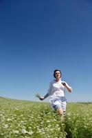 Young happy woman in green field photo