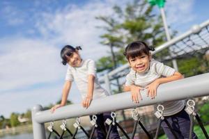 Little school kids climbing in the school playground. photo