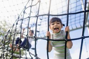 Little school kids climbing in the school playground. photo