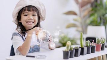 Little girl watching a plant. Environmental technology concept. Sustainable development goals. SDGs. photo