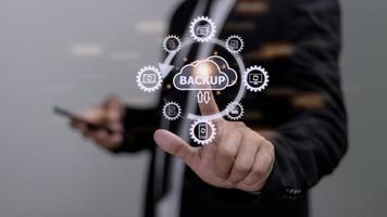 Backup files and data on internet with cloud storage technology that sync all online devices and computers with network connection, protection against loss, business person touch screen icon concept photo