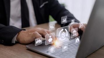 Businessman using a computer to Concept of fund financial investment management portfolio diversification photo