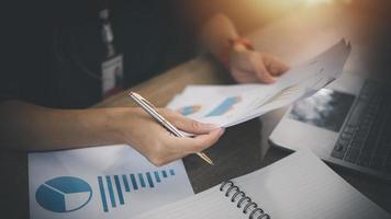 Business Woman Writing with pen in notepad photo