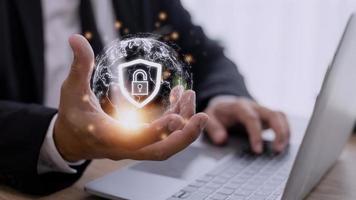 Cyber Security Internet And Networking Concept. Businessman Hand Working With laptop computer and virtual Screen Padlock Icon. Digital crime by an anonymous hacker, data protection. photo