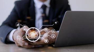 man use Laptop with cloud computing diagram show on hand. Cloud technology. Data storage. Networking and internet service concept. photo