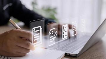 Paperless workplace ideas, e-signing, electronic signature, document management. A businessman signs an electronic document on a digital document on a virtual screen. photo