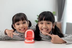 little girl smiling with a happy and cool smile on face. showing teeth. photo