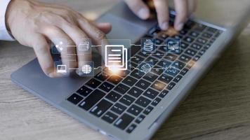 Businessman using a computer to document management concept, online documentation database and digital file storage system software, records keeping, database technology, file access, doc sharing. photo