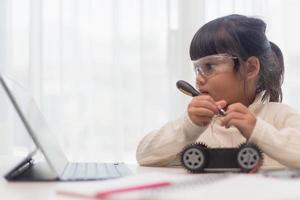 Asian students learn at home in coding robot cars and electronic board cables in STEM, STEAM, mathematics engineering science technology computer code in robotics for kids concept. photo