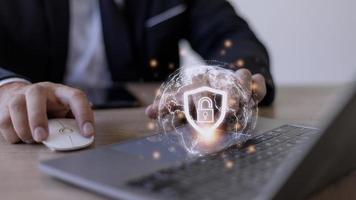 Cyber Security Internet And Networking Concept. Businessman Hand Working With laptop computer and virtual Screen Padlock Icon. Digital crime by an anonymous hacker, data protection. photo