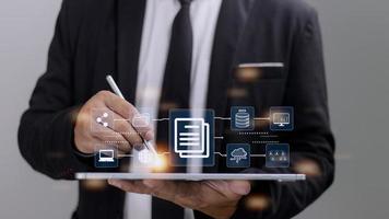 Businessman using a computer to document management concept, online documentation database and digital file storage system software, records keeping, database technology, file access, doc sharing. photo