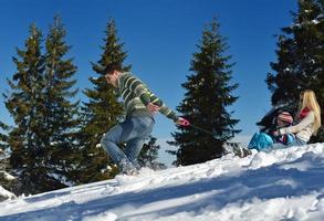 family having fun on fresh snow at winter photo