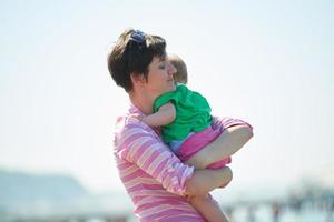 mom and baby on beach  have fun photo