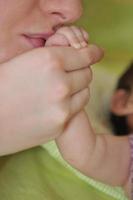 beautiful young mother hold small children hand photo