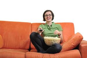 young woman eat popcorn and watching tv photo