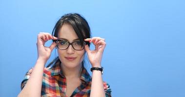 woman smiling wearing on a pair of large glasses photo