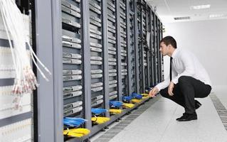 young it engeneer in datacenter server room photo