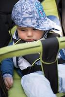 baby boy sitting in the pram photo