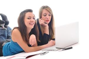 two young girls work on laptop isolated photo