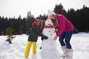 happy family building snowman photo