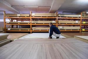 carpenter measuring wooden board photo