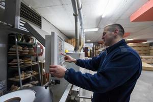 carpenter calculating and programming a cnc wood working machine photo