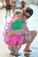 mom and baby on beach  have fun photo