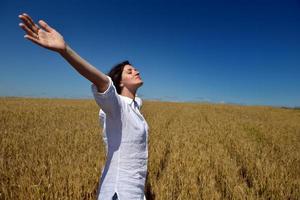 young woman in wheat field at summer photo