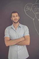 portrait of man in front of black chalkboard photo