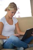 woman using a laptop computer at home photo