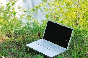 Laptop on grass photo