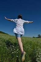 Young happy woman in green field photo