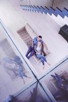 youg couple in living room with tablet top view photo