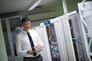 network engineer working in  server room photo