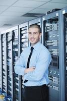 young it engineer in datacenter server room photo