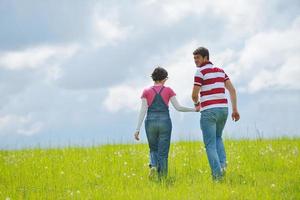 Portrait of romantic young couple smiling together outdoor photo