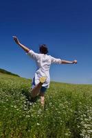 young woman with spreading arms to sky photo